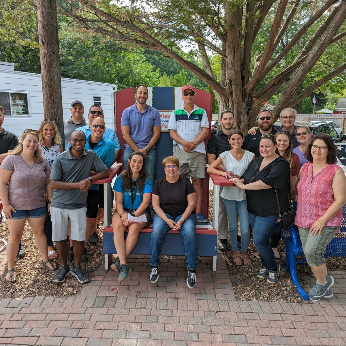 group of accountants enjoying firm culture at a mini golf outing in Rochester, NY