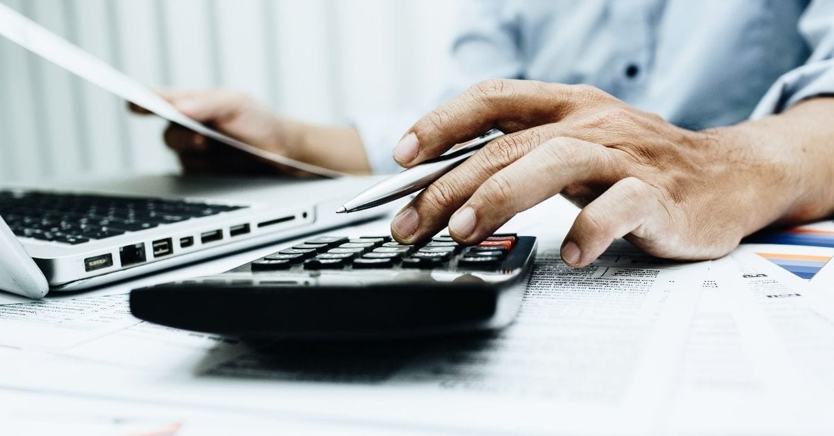 man using calculator for loan forgiveness application