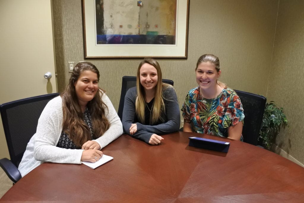 staff in a conference room ready to discuss their first year in accounting