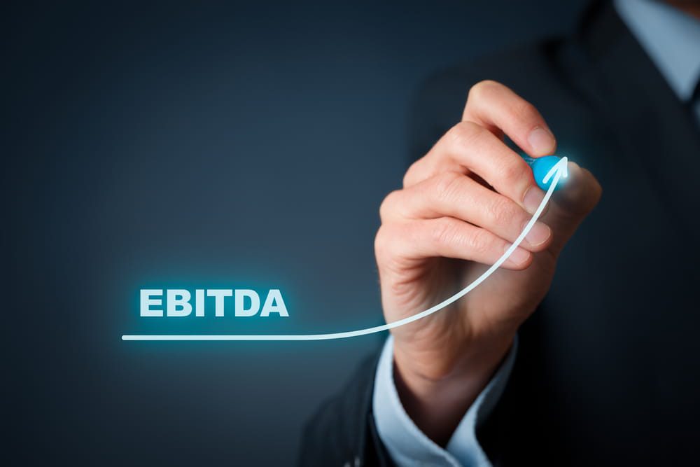 Businessman draw graph with growing EBITDA