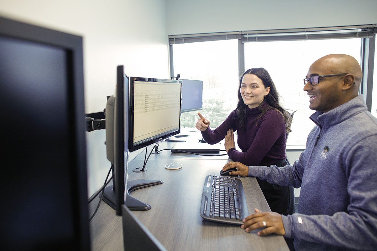 Employees working together at computer