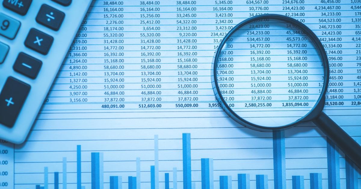 demystifying plan audits with magnifying glass over plan audit document and calculator