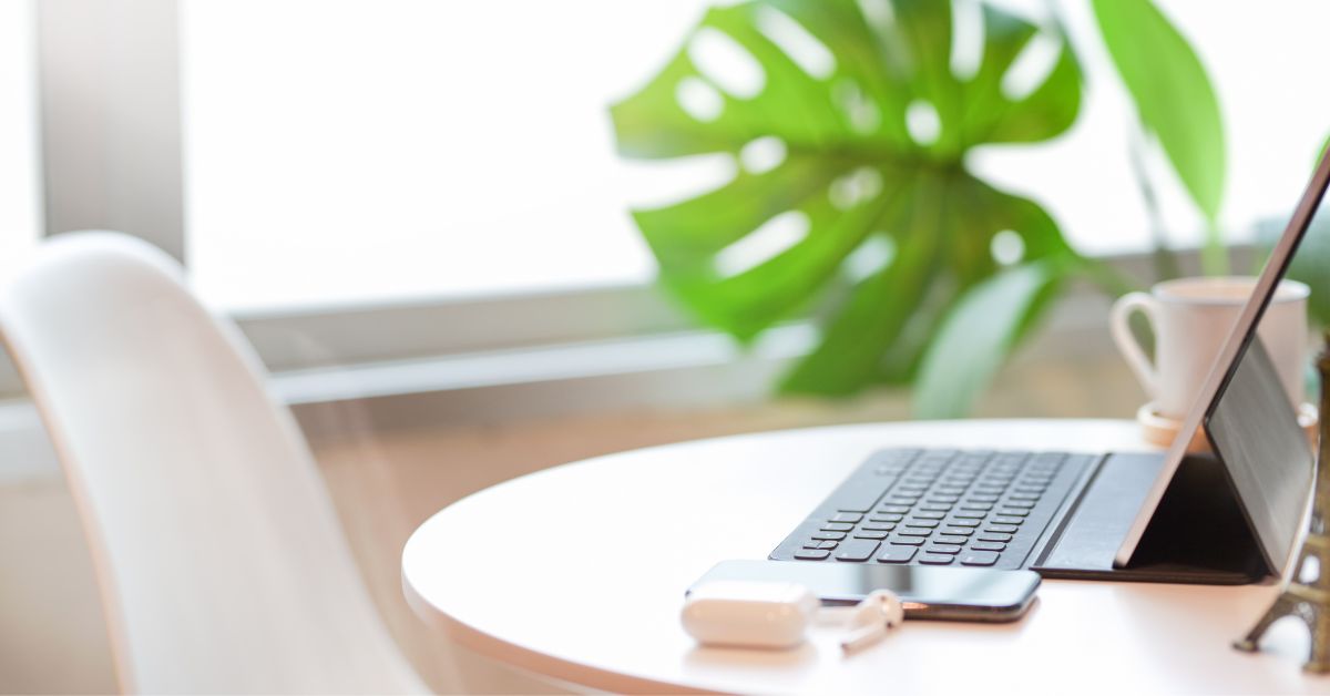 When should attorneys and law firms outsource accounting desk with white chair and laptop computer and monstera leaf