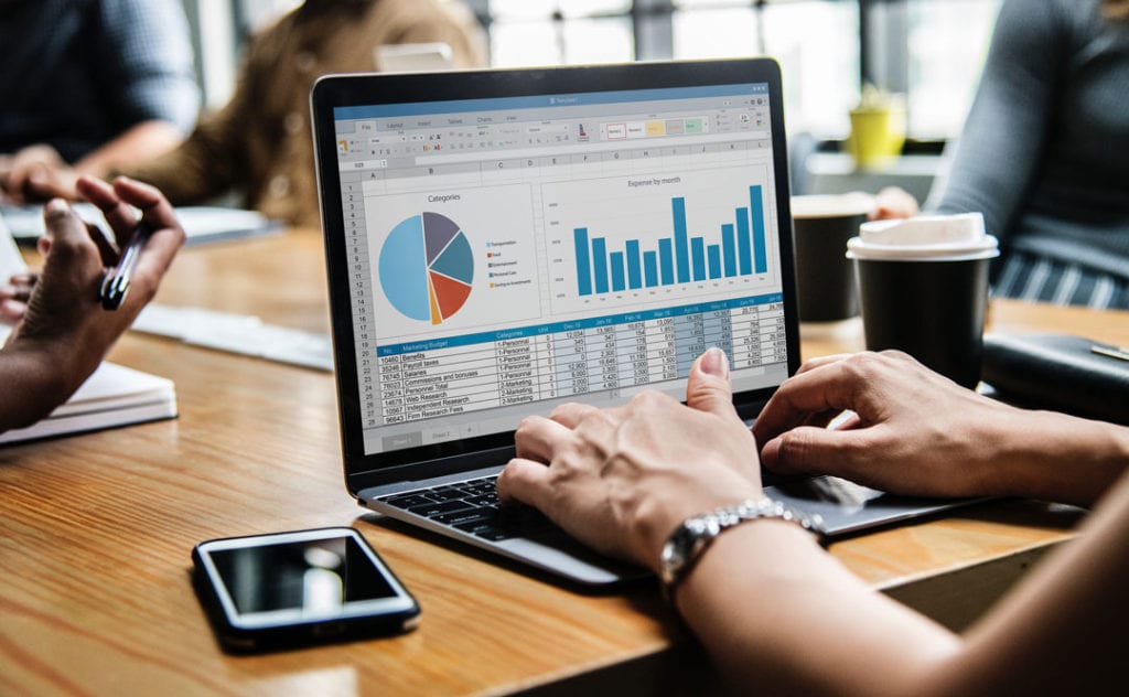 women at computer working on charts