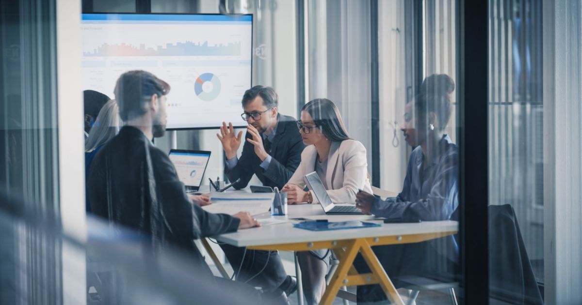 Business Team Meets in a Glass Office