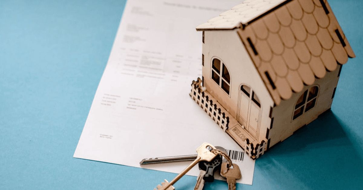 model toy house with keys and paper