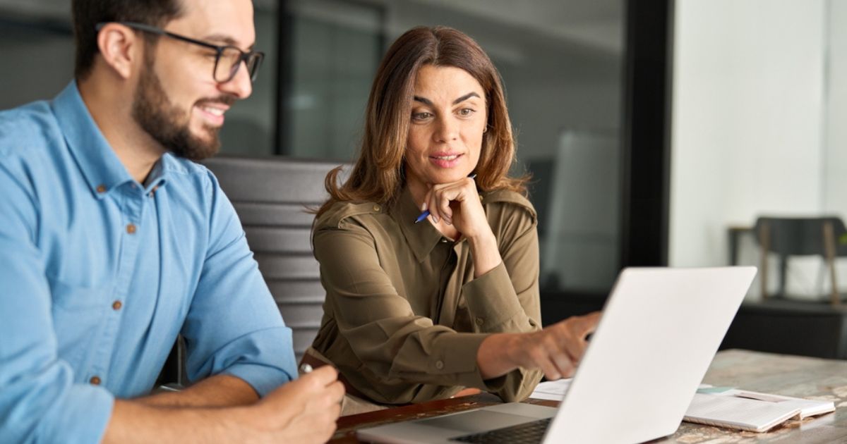 man and woman looking at a laptop