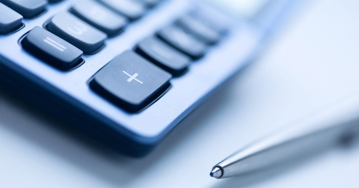 photo of a calcluator and pen, symbolizing strategies for streamlining the grant management process